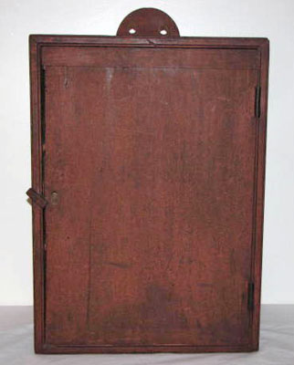 Hanging school book cupboard in red painted dry surface