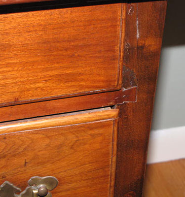 18th century Queen Anne Lowboy with fan carving, acorn drops, and dovetailed case with pad feet in old finish.